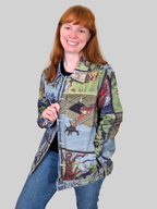 Woman wearing the Wizard of Oz Denim Jacket open over a black top and jeans, front view