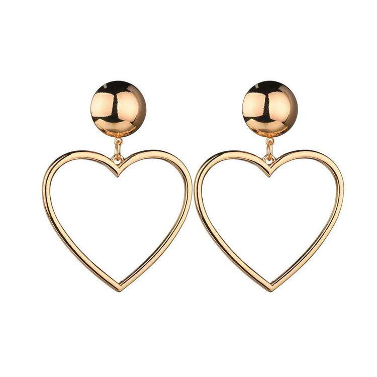 Pictured is a pair of heart-shaped hoop style earrings dangling from ball-shaped closures at each ear lobe in gold tone.